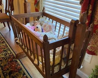 (F30) $85. Solid wood cradle that rocks or can be locked in place.  Measures 21" wide x 40" long x 38" tall. 