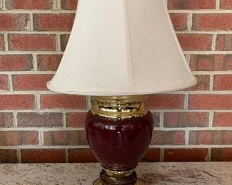 (L13)$20 dark red & brass lamp.  measures 24” tall. 