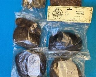 Box of Doll Wigs Assorted Colors. Box of 24 doll wigs. Assorted colors from blonde, brunette and black. Assorted sizes from 10' to 15'. Synthetic fiber.