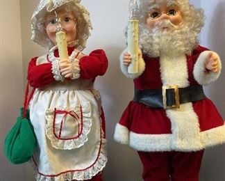 Mr and Mrs. Claus. Mr & Mrs Santa Claus holding candles. They plug into 110 volt outlet. The candles light up.