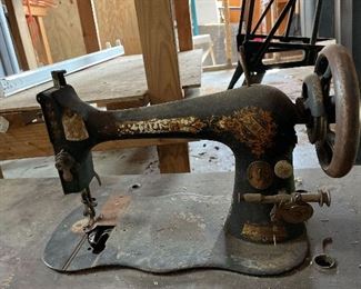 Pre 1900 Singer Sewing Machine (Serial #11120147) with Stand and Cover. Very old Singer sewing machine with base which has mechanical foot control - has wooden cover.