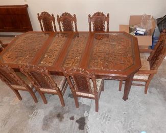 Asian Deep relief carved "Chinoiserie" under glass dining table...solid mahogany with 2 expansion leaves, 2 arm chairs and 6 side chairs...excellent condition...nothing to apologize for.