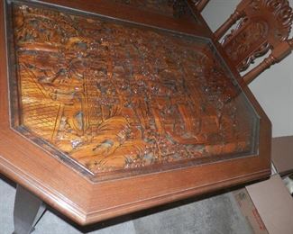 Hard to photograph ....deep relief carving under glass...(dining table)