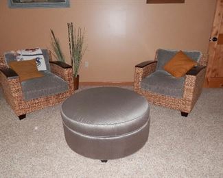 Great pair of heavy wicker or "popcorn" wicker club chairs, each with solid mahogany armrests.   In the center is a "Tuffet" with removable cushion and storage inside