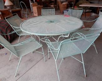 Vintage all steel patio set.....52 inch umbrella table and 6 matching arm chairs.....could us a good paint job!