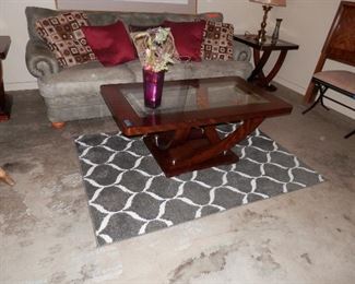 3 piece contemporary coffee table set with 2 matching end tables all 3 with beveled glass....geometric rug too!.....throw pillows in background.....2 of which are suede leather