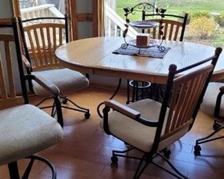 casual dining table and four upholstered chairs with wood and wrought iron, has two matching barstools