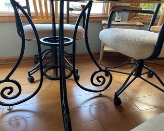 wrought iron base of casual dining table and chairs