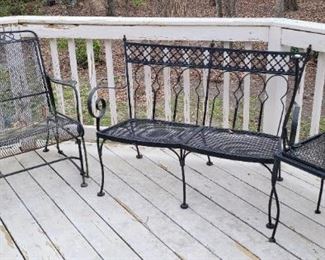 two wrought iron settees 