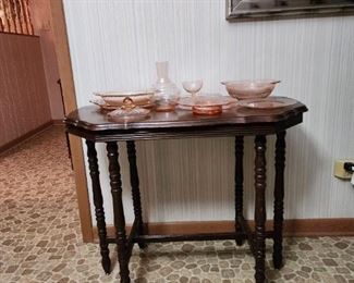 Antique side table with some of the pink depression glass