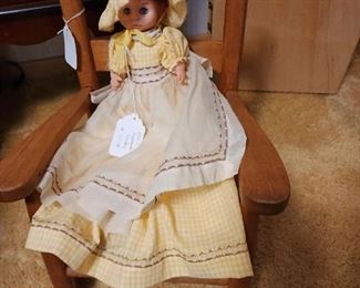 Child's wooden rocker and doll