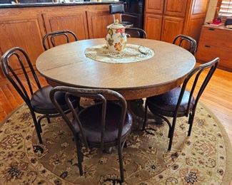 Antique dining table. Sold with 6 metal chairs. Sold  AS a set. 