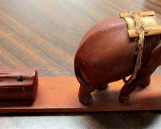 Teak Elephant incense burner off pile of teak he is puling