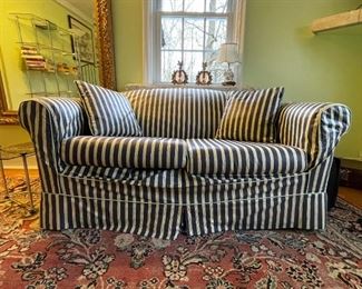 Sleeper love seat couch with striped slipcover