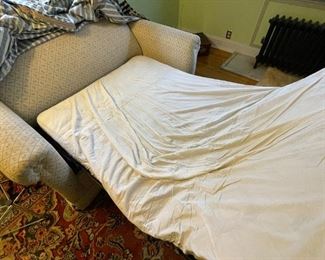 Sleeper love seat couch with striped slipcover