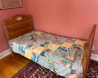Wooden twin bed with bedding and mattress