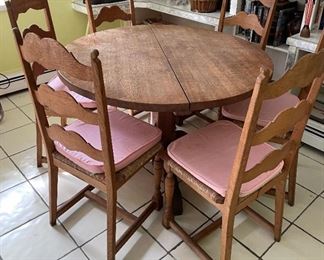 6 chair, round wooden table with light pink cushions 