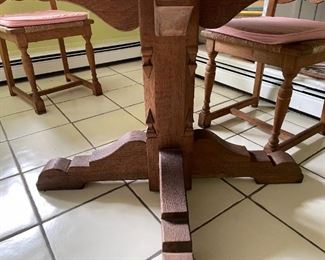 6 chair, round wooden table with light pink cushions 