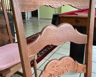 6 chair, round wooden table with light pink cushions 