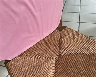 6 chair, round wooden table with light pink cushions 