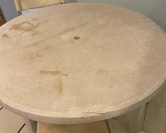 Rounded white table with two metal matching chairs