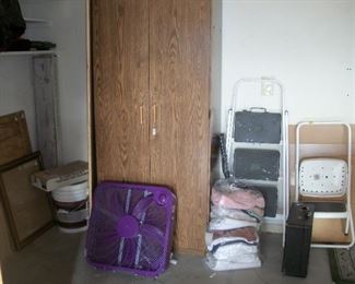 cabinet, fan, step stools, bags of rags