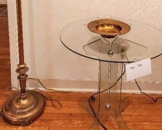 Heavy brass floor lamp, glass table. 