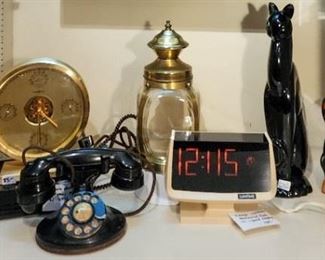 Bakelite rotary phone, Royal Haegar winking sphinx/cat, rare Lumitime mechanical movement clock with electric lighted back panel (c. 1972) Howard Miller clock. 