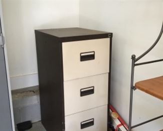 Three drawer file cabinet.