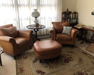 Immaculate leather chairs and ottoman 