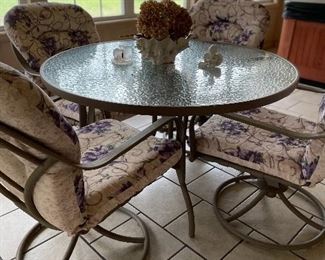 Glass top table & 4 swivel rocking chairs