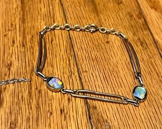 Sterling and maybe a synthetic “foil” Opal. 