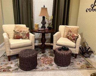 Pair of club chairs, pair of woven ottomans, rug, round pedestal table