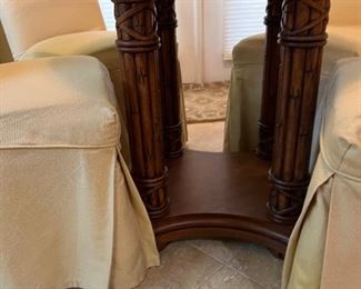 Glass top rattan table and 4 parsons chairs with M monogram on back of chair.  