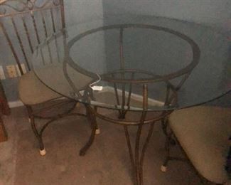 Table and 4 chairs - $75.00  -   43" diameter glass top table setting on gold colored pedestal 30"high with 4 ornate padded chairs.