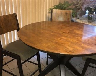 Table - $150.00   -   50" diameter round top table on crossed leg pedestal, 36" high,  with 4 bar height cushioned chairs.  Good Condition