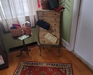 Purses, jewelry console, cute round table, rug