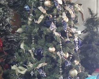 Many pre-decorated Christmas trees, sold as-is