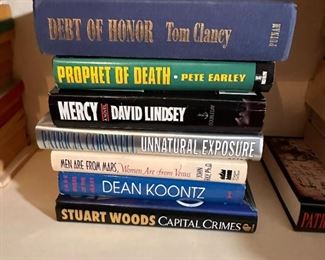 Group of hardcover books including Dean Koontz and Tom Clancy