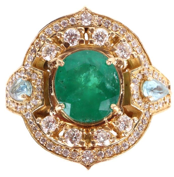 18k yellow gold handmade custom ring with one 11.7 X 13.0mm oval emerald estimated to be 7.5-7.0ct, eight 0.10ct round diamonds, two 0.02ct round diamonds, thirty-six 0.005ct round diamonds,thirty-six 0.01ct round diamonds, and two 0.50ct teardrop aquamarine stones. This ring was custom made by a Brazilian jeweler who crafted the gold by hand, he is known for hand-selecting the gemstones free-diving in the Amazon river, this talented jeweler all but cut the gemstones himself. 