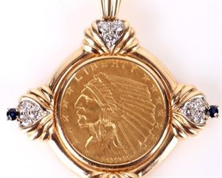 90% gold 1908 Indian head $2.5 coin with a 14k yellow gold pendant bezel with twelve 0.03ct rund white sapphires, and three 0.02ct round blue topaz. 