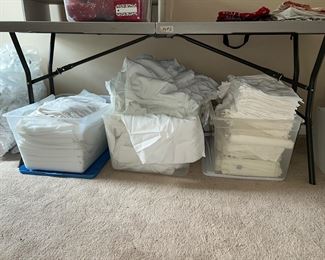 Large number of tablecloths, napkins, chair covers