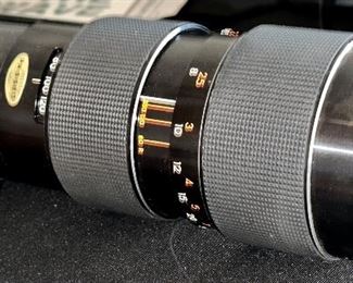 Pair of Camera Lenses and Cases: Tamron 80-200mm Zoom and the other is a Nikon 50 mm Lens.