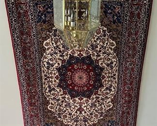 An absolutely stunning Isfahan Persian rug hanging on the wall.  It doesn’t get any nicer!  Signed in Arabic on  the fringe edge.