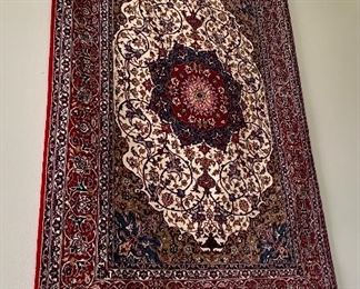 An absolutely stunning Isfahan Persian rug hanging on the wall.  It doesn’t get any nicer!  Signed in Arabic on  the fringe edge.