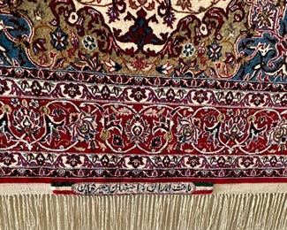 An absolutely stunning Isfahan Persian rug hanging on the wall.  It doesn’t get any nicer!  Signed in Arabic on  the fringe edge.