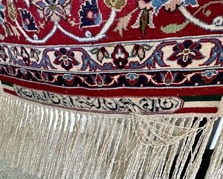 An absolutely stunning Isfahan Persian rug hanging on the wall.  It doesn’t get any nicer!  Signed in Arabic on  the fringe edge.