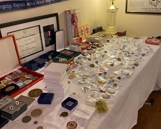On this table are coins, pins, and more