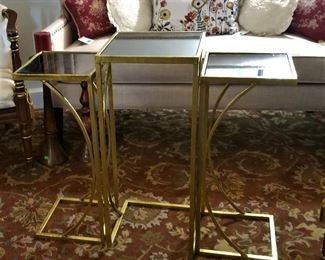 Mid-century modern style gold and black glass trio of tables. Use them for snacking trays and configure them nesting or apart or together