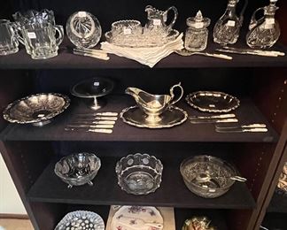 Dining Room 
A collection of  crystal, mother of Pearl and  silver plate serving pieces.
Lower shelf is Fenton, Murano Crystal and Royal Albert china serving plate and server. 